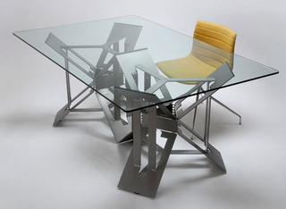 Illustration for article titled Futuristic Origami Desk Cut and Folded from a Single Sheet of Steel